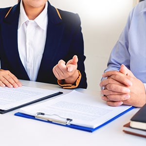 A person is discussing a workplace injury case with a lawyer - Leep Tescher Helfman and Zanze
