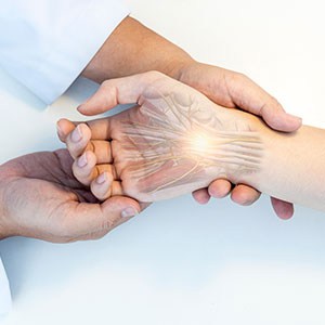 A medical diagram of a hand with compressed nerves, indicating carpal tunnel syndrome - Leep Tescher Helfman and Zanze