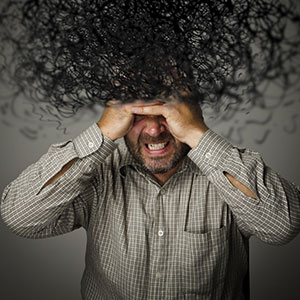 A man holding his head in pain representing Stress Injury - Leep Tescher Helfman and Zanze