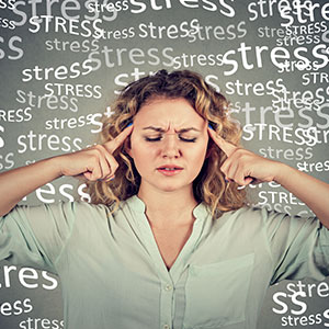 Stressed woman with stress words on background. Depicting the concept of stress injury. - Leep Tescher Helfman and Zanze