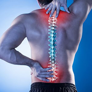 A person holding his lower back in pain, indicating a back injury - Leep Tescher Helfman and Zanze
