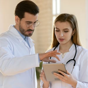 Two Qualified Medical Examiner engaging in a discussion - Leep Tescher Helfman and Zanze