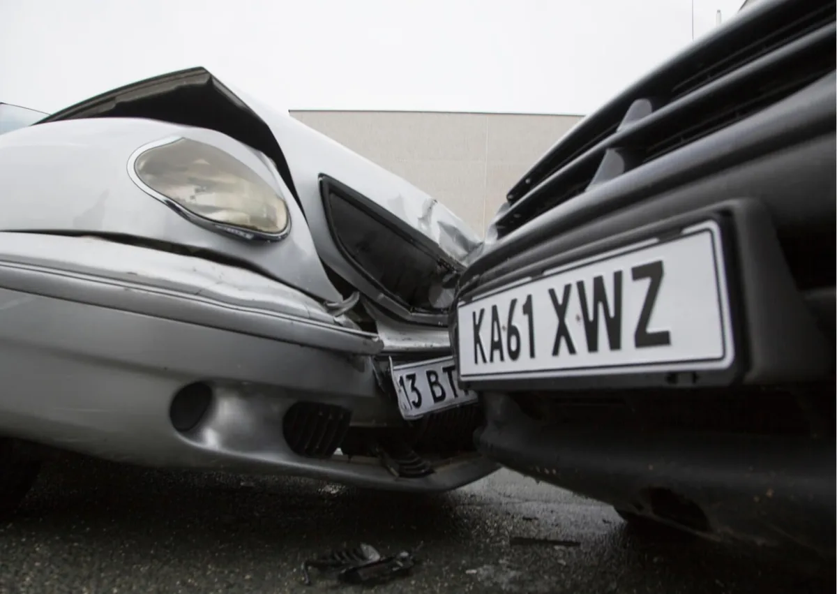 Front-end collision between two vehicles, illustrating a car accident at work that may lead to a workers' compensation or third-party injury claim.